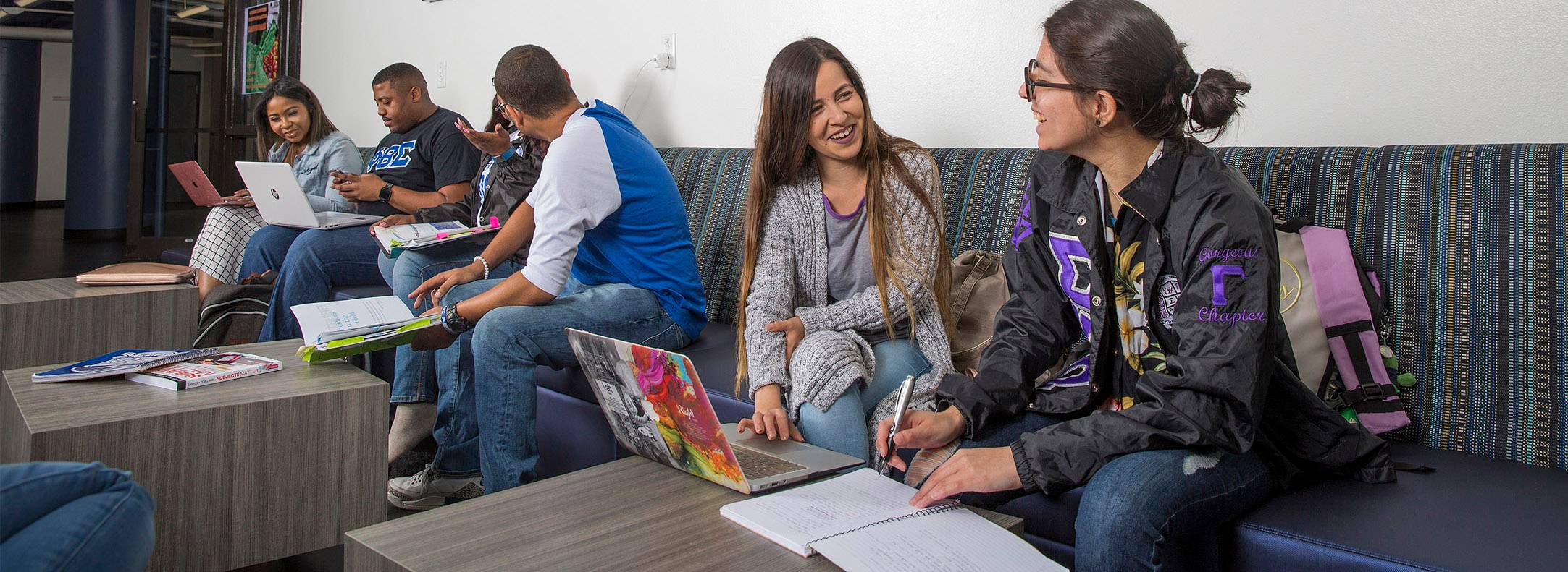 UHD students in the student lounge studying and talking 