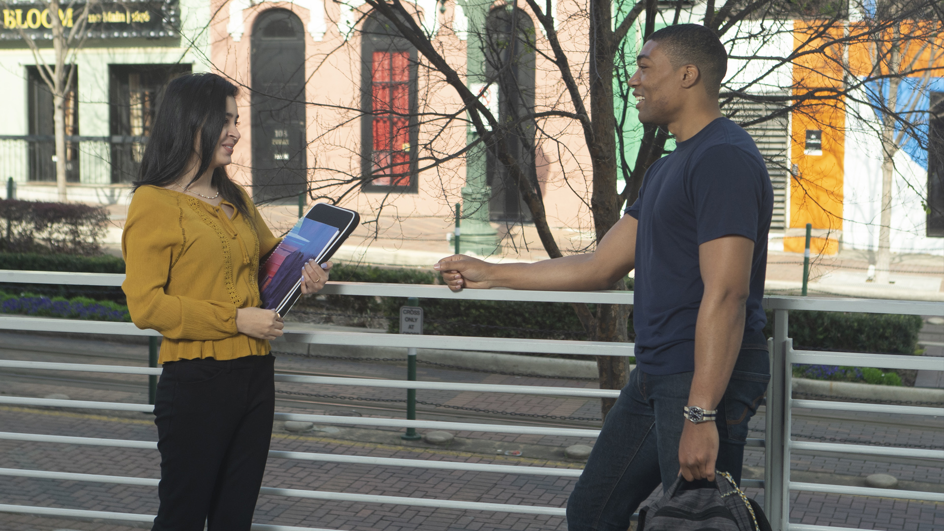 female UHD student talking to a male UHD student on the street downtown