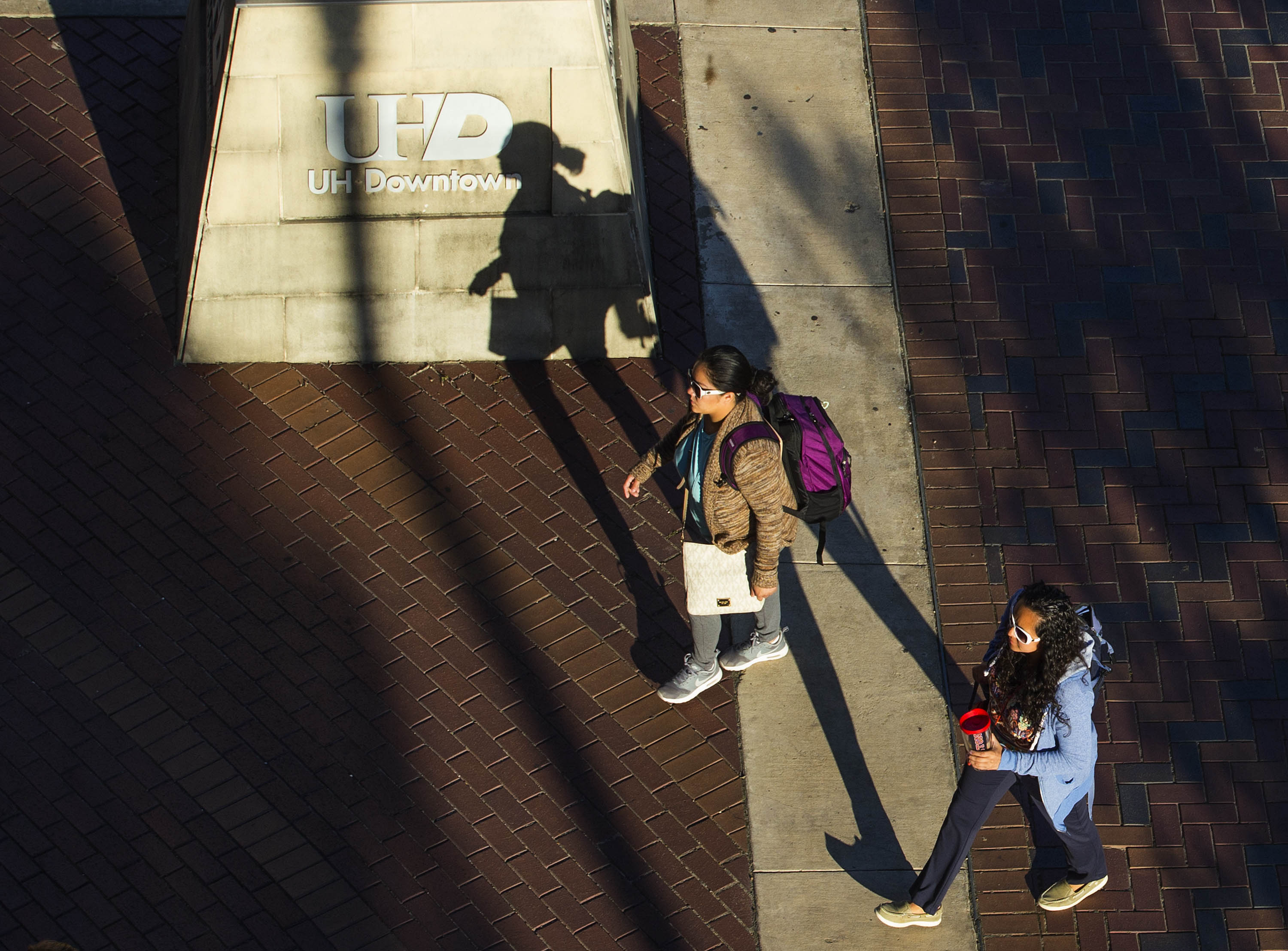 Student walking towards the Commerce building