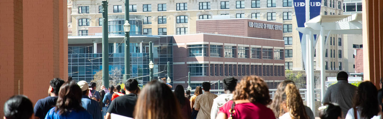 Students walking towards College of Public Service Building