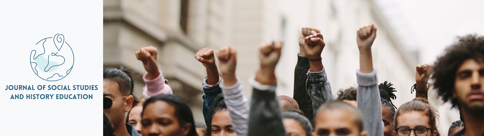 People at a protest with their fist raised. People at a protest with their fist raised.