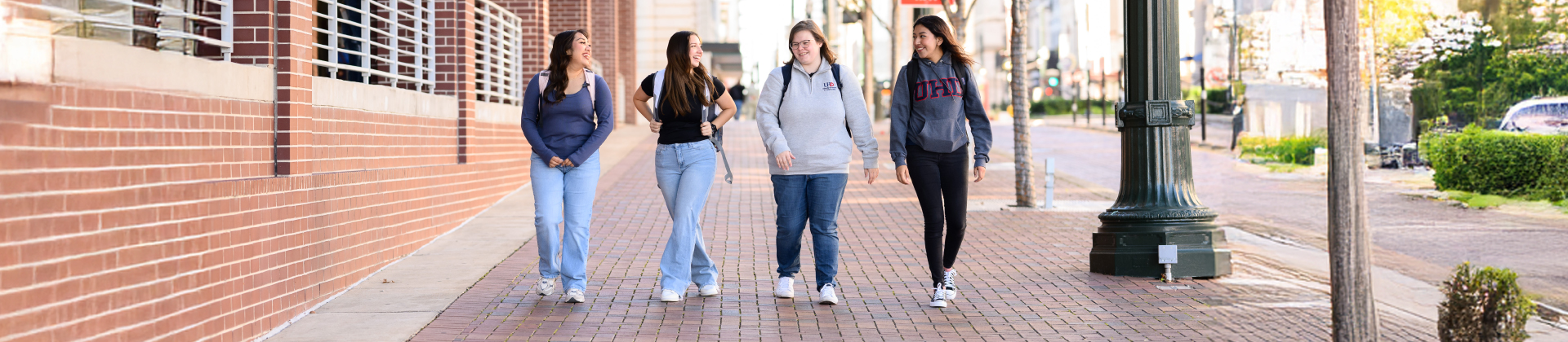 UHD Students walking by Commerce Street Building