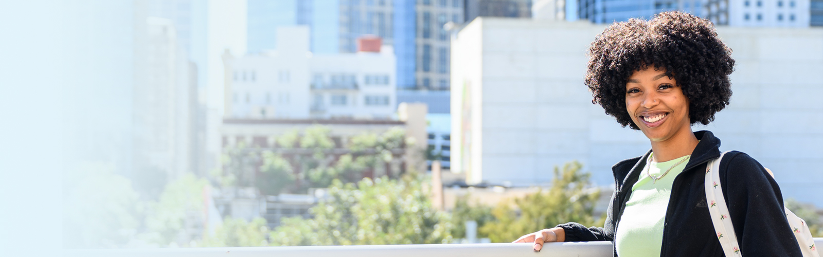 woman standing in front of downtown building 