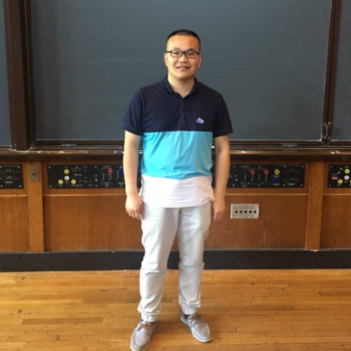 Dr. Li standing in front of a chalkboard.