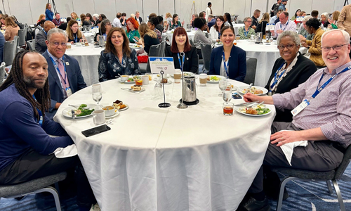 President Loren Blanchard ( second from left) and Dr. Zeenat Mitha ( third from left) sharing a meal with th attendees at CUMU conference in the Fall 2024 in Minneapolis, Minnesota.&nbsp;