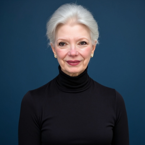 Angela blanchard wears a turtle neck and smiles