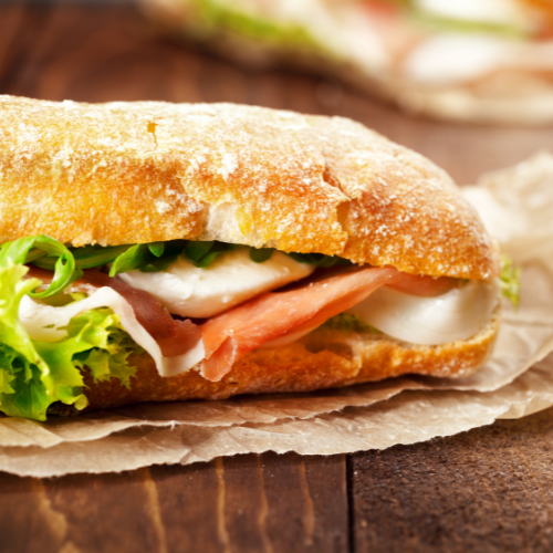 A sandwich with meat, cheese, and lettuce 