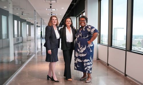 Three University of Houston-Downtown alumni and Houston area judges smile at UHD at 1801 Main in Downtown Houston. 