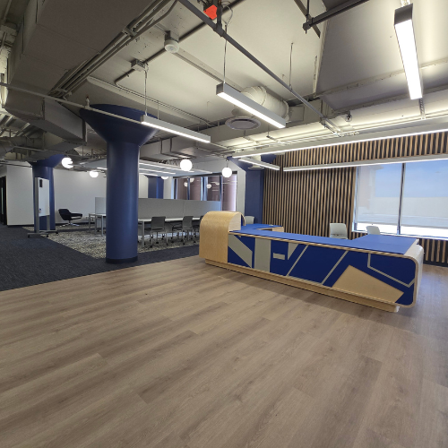 Open concept space with chairs, desks, and blue, grey, and light wood accents on the university of houston downtown's fifth floor 