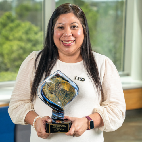 Gladis Moya holds the President's Staff Excellence Award at the University of Houston Downtown