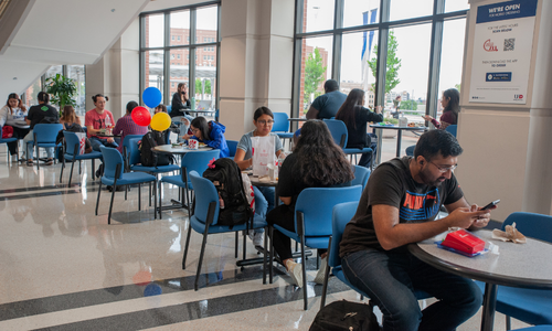University of Houston Downtown students sit at tables in the university's skyline lounge 