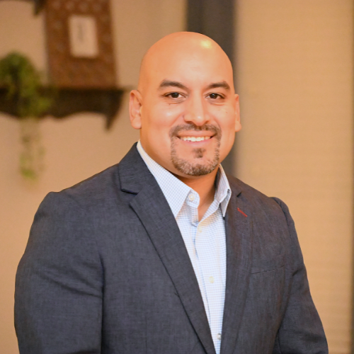 Elias Rivera, university of houston-downtown alum and adjunct professor at the college of public service, smiles